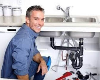 plumber  working under sink